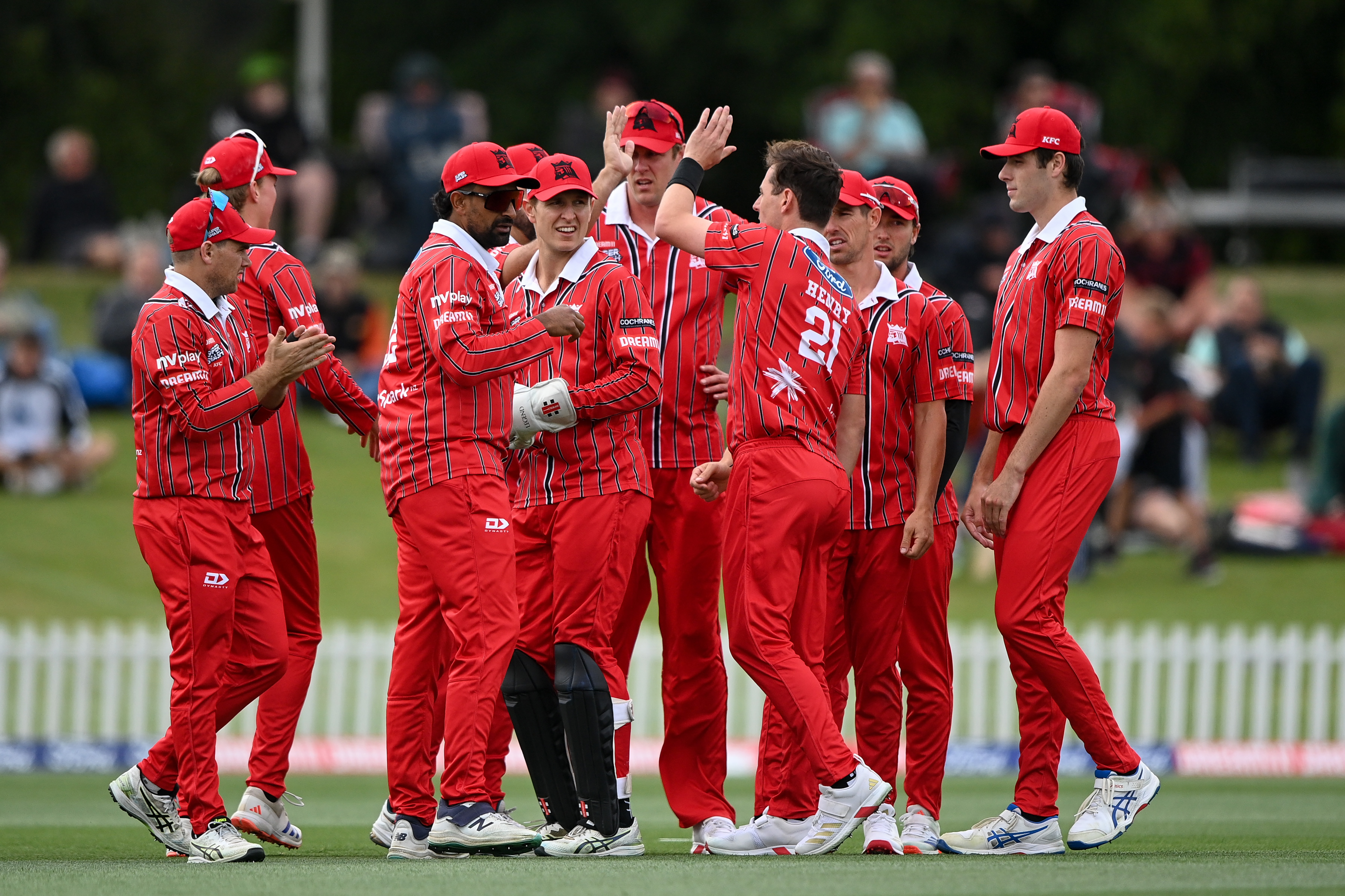 Canterbury Cricket Club players celebrating with NV Play logo on arm