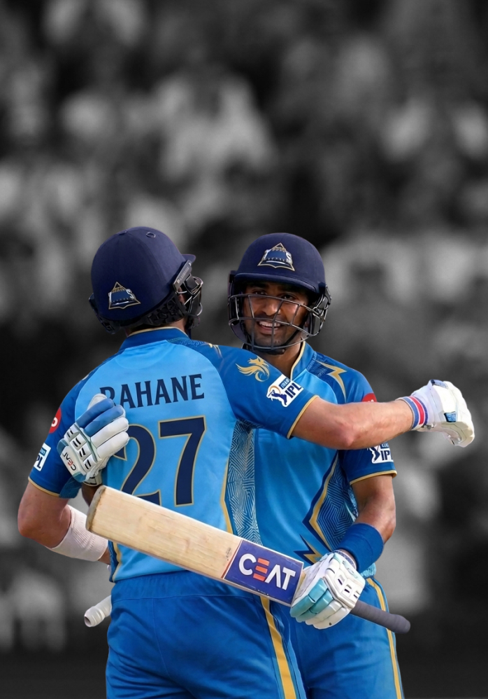 Two professional cricketers in blue uniforms hugging in full stadium